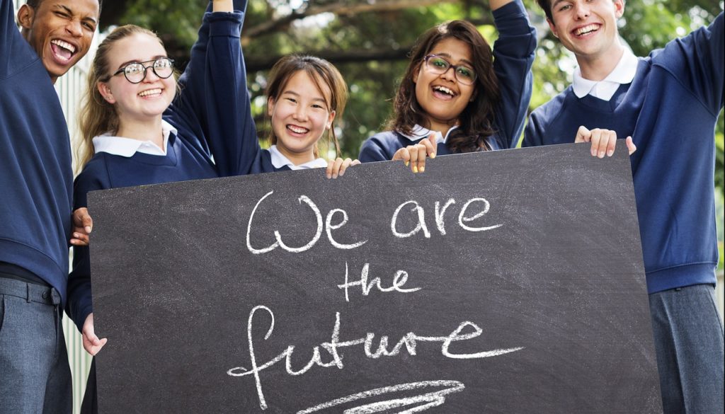 Group of senior school kids holding a banner