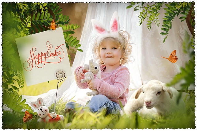Child sitting in an Easter themed garden with rabbits and lambs