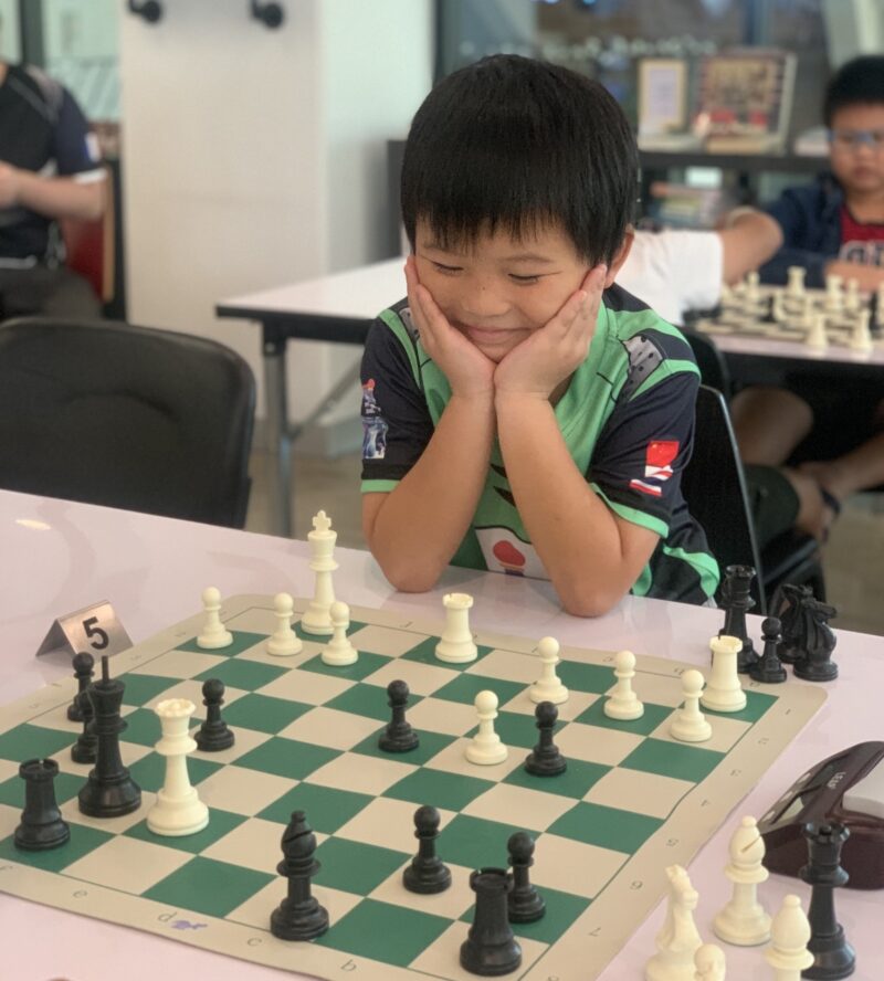 Boy playing chess at Happy Pawn Chess Club