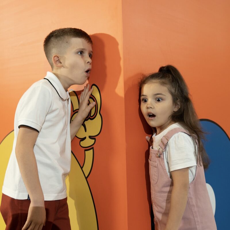 WOW park with boy and girl against the wall