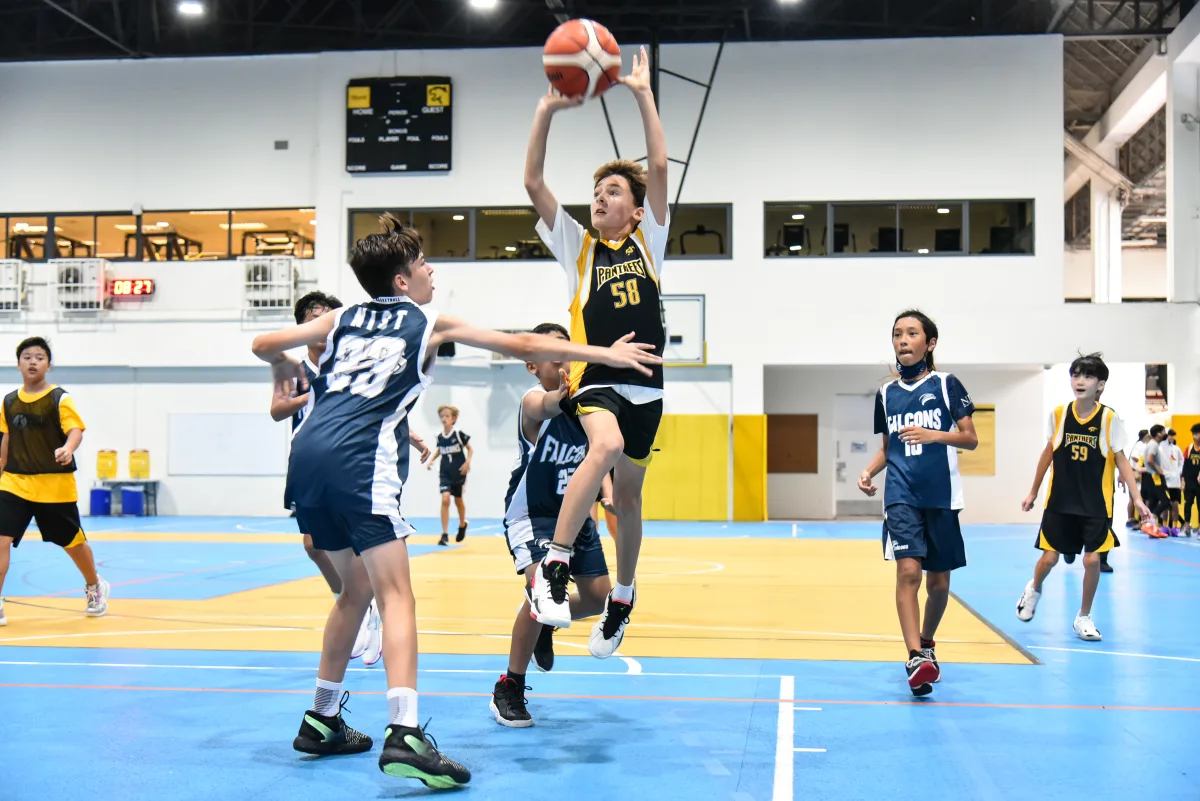 Kids play basketball at ISB