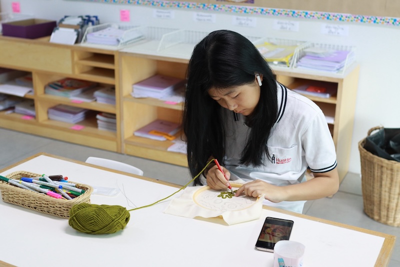 Girl is knitting in Class at Hua Hin International School