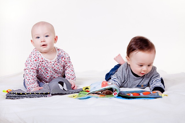 2 small babies looking at books