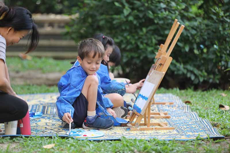 Bangkok Patana - student painting outdoors