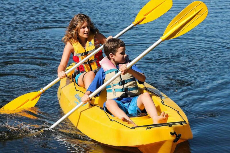 Two Kids kayaking in a lake