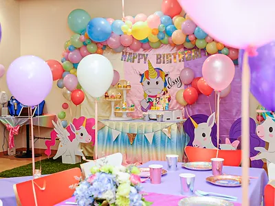 Room displaying a unicorn themed birthday party setting