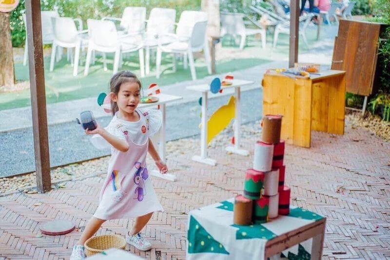 Children playing with colored paper cups