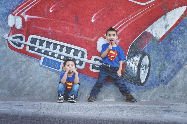 2 boys pretending to be superman