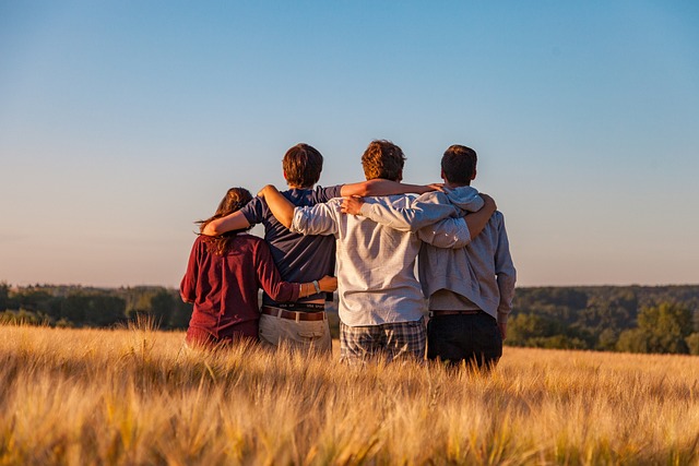 Group of teens sitting in a field