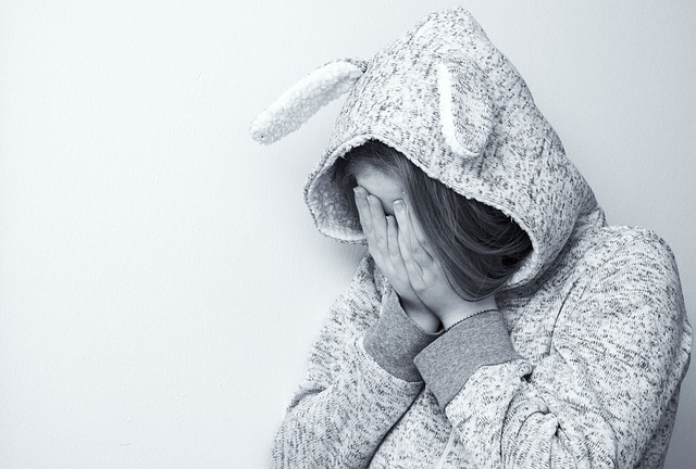 Young girls dressed in a hoodie feeling sad